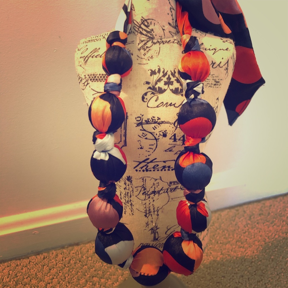 Synthetic silk covered beads necklace.
